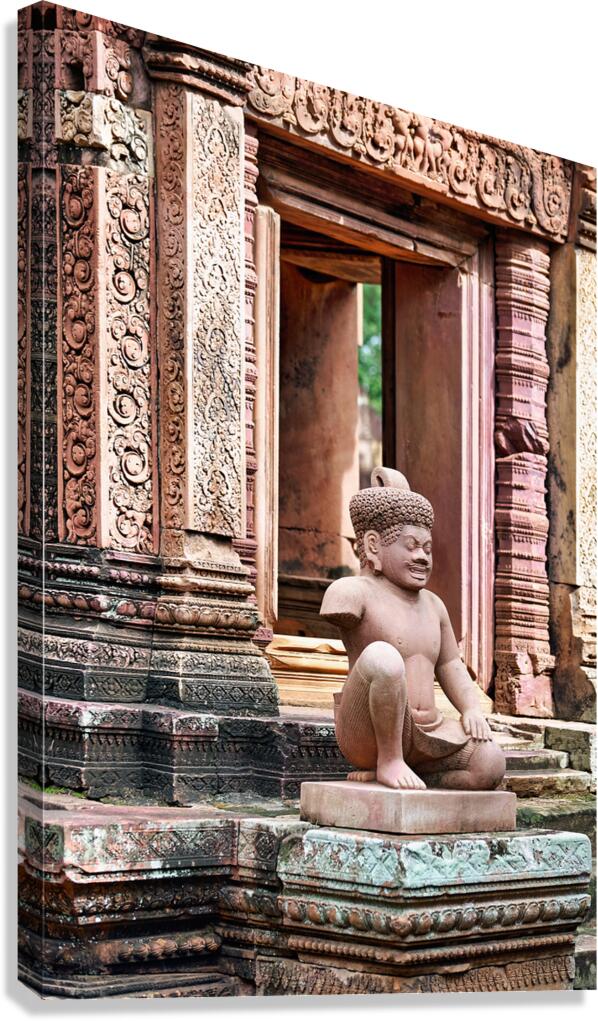Ancient Khmer temple with detailed carvings and a stone guardian