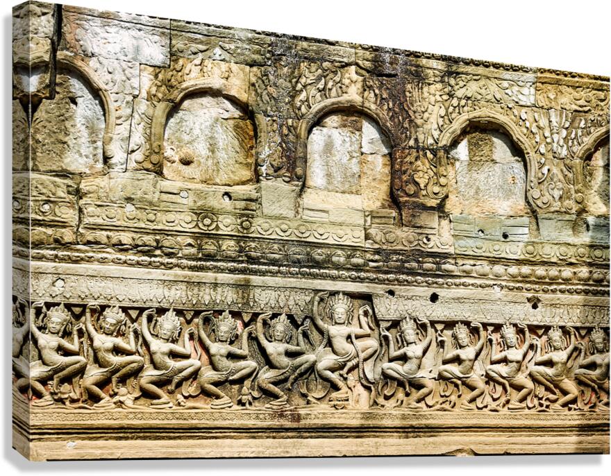 Ancient Khmer temple wall with dancing Apsara bas reliefs.