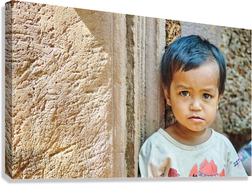 Expressive child portrait against ancient stone texture.