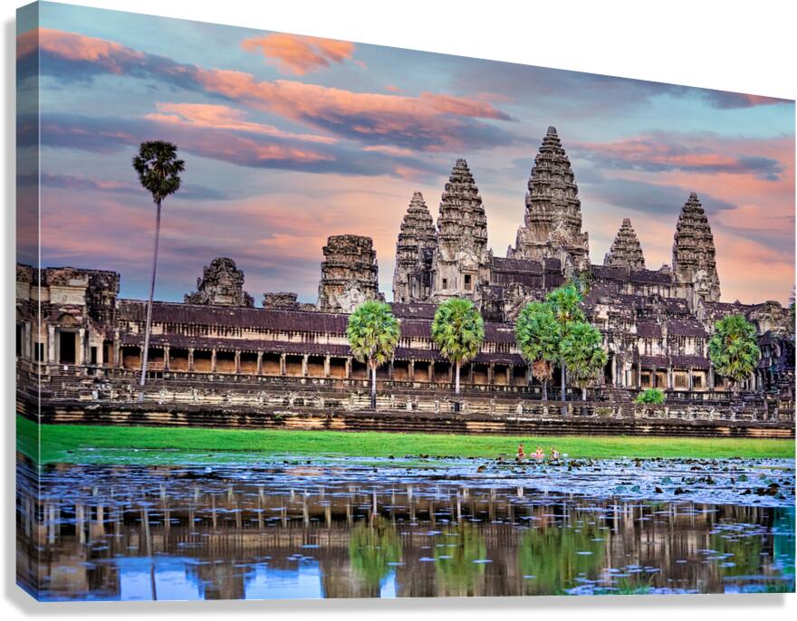 Angkor Wat temple at sunset reflected in a lotus pond.