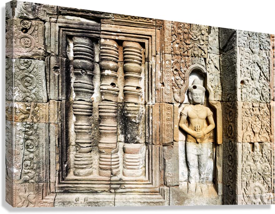 Ancient temple wall with intricate stone carvings and a figure.