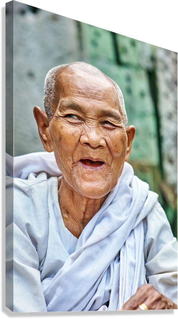 Elderly person in white shaved head smiling portrait.
