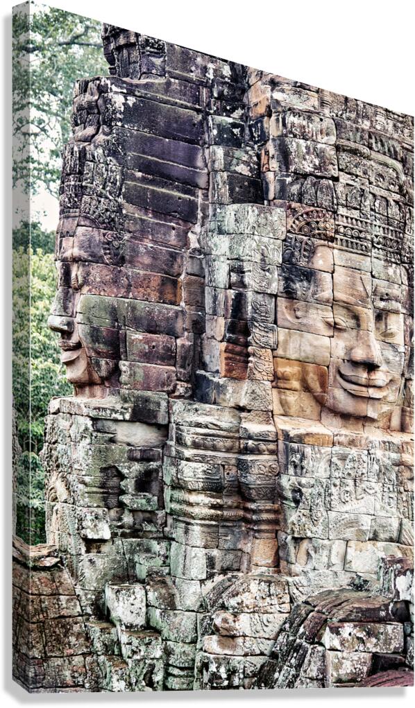 Ancient stone faces carved into a temple wall.