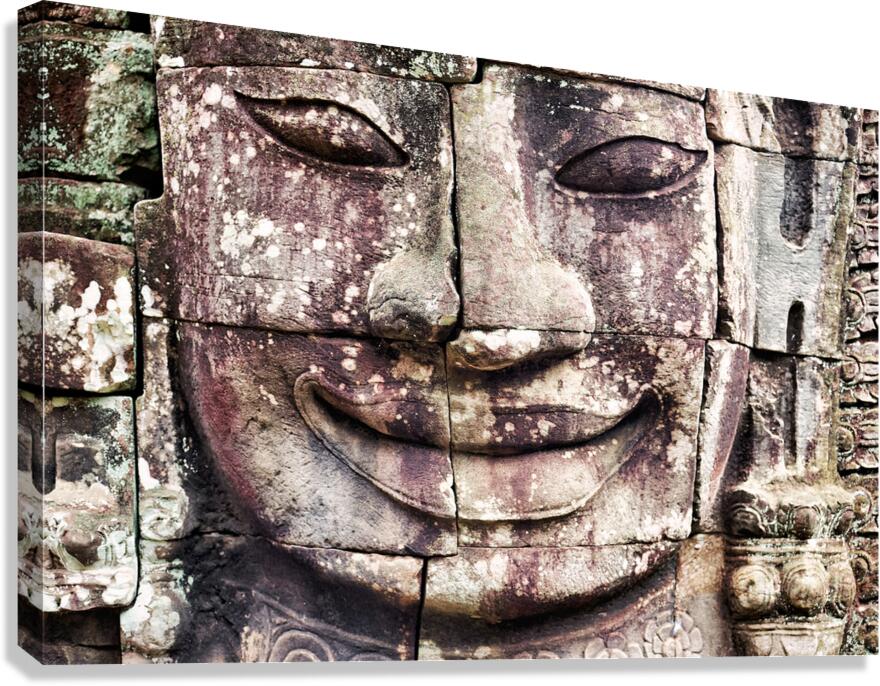 Ancient stone face carving with serene expression.