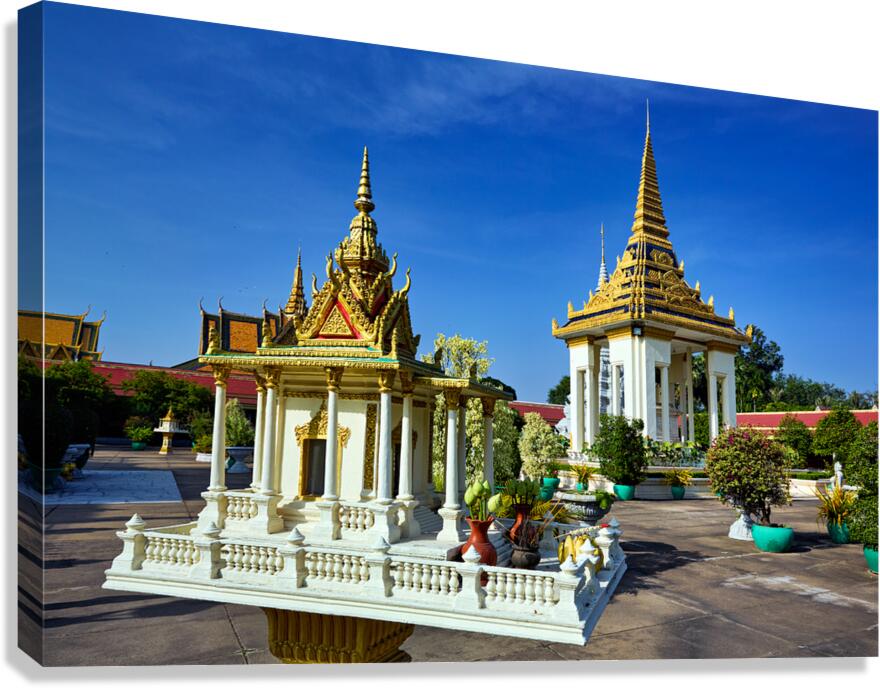 Ornate Cambodian temples under a clear blue sky.