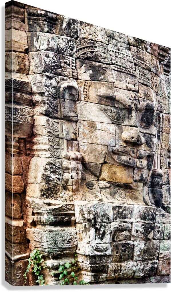 Ancient stone face carved into temple wall.