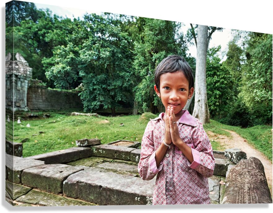 Smiling child offers traditional greeting at ancient temple ruin