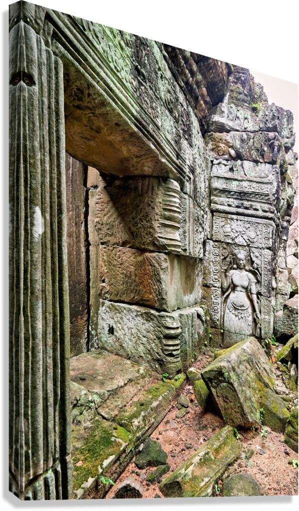 Ancient temple ruins with carved stone deity and moss.