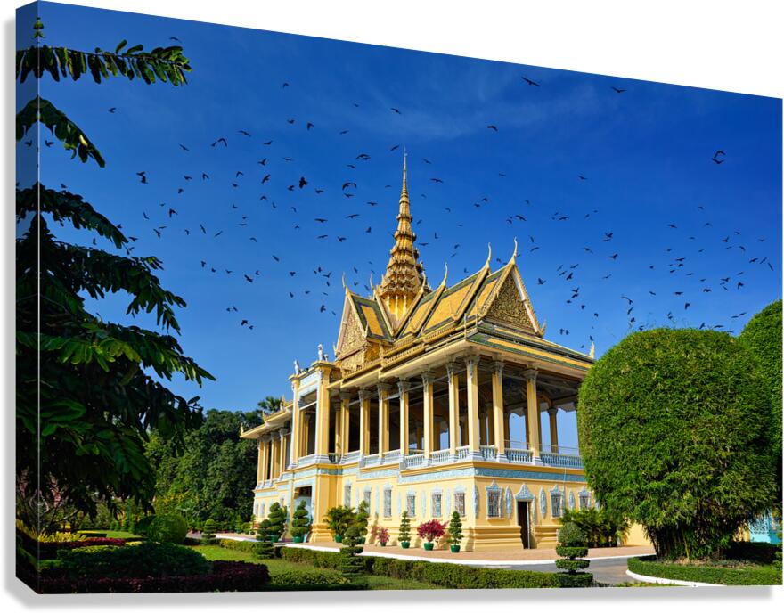 Majestic golden temple birds soaring in clear blue sky.