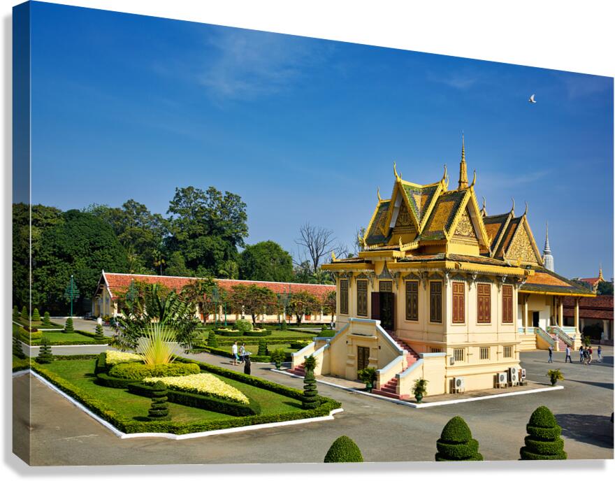 Golden roofed Cambodian palace manicured gardens and clear blu