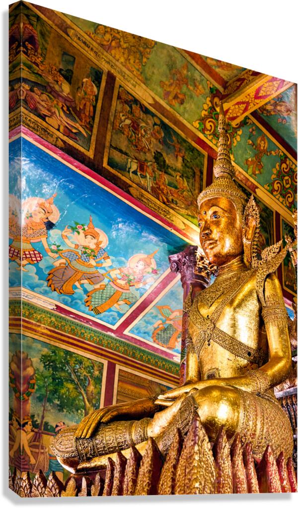 Golden Buddha statue in ornate temple with colorful murals.