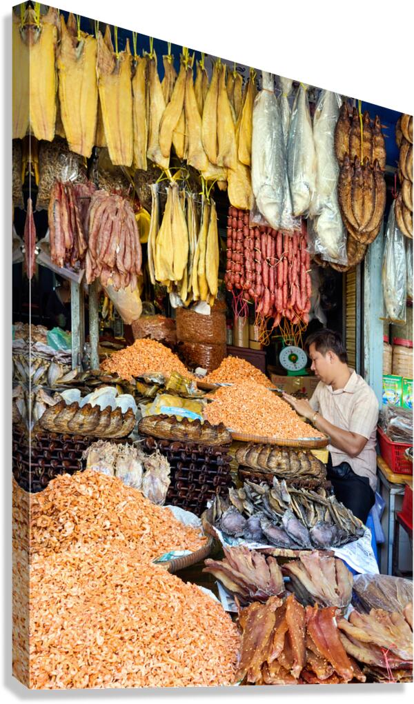 Dried fish shrimp and sausages for sale at market stall.