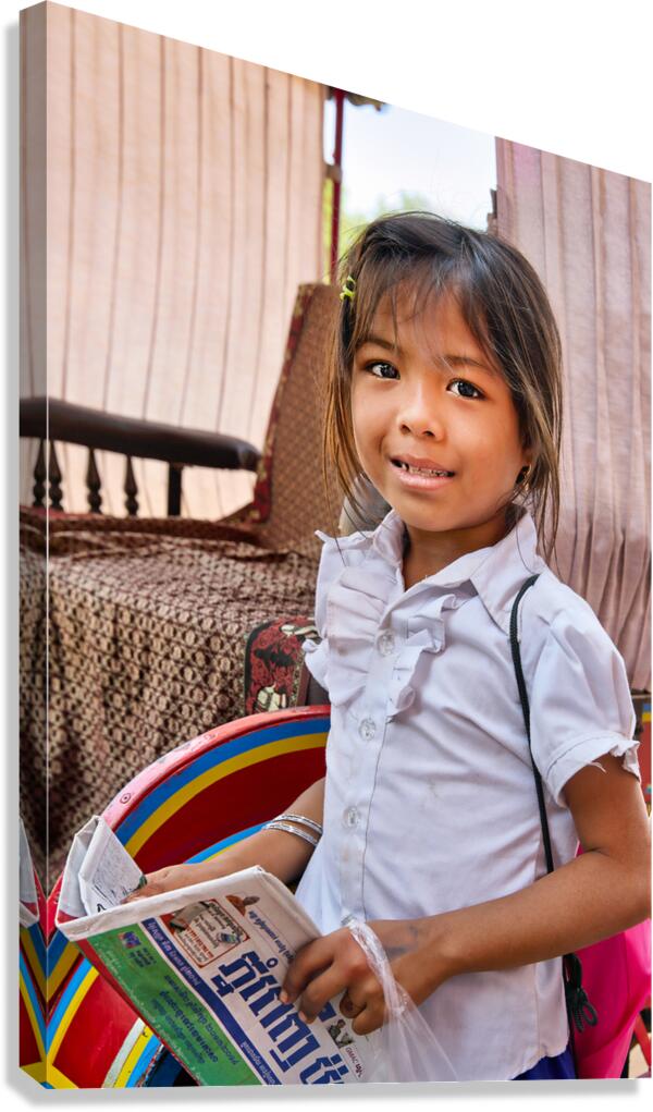 Smiling girl holds newspaper in a colorful carriage.