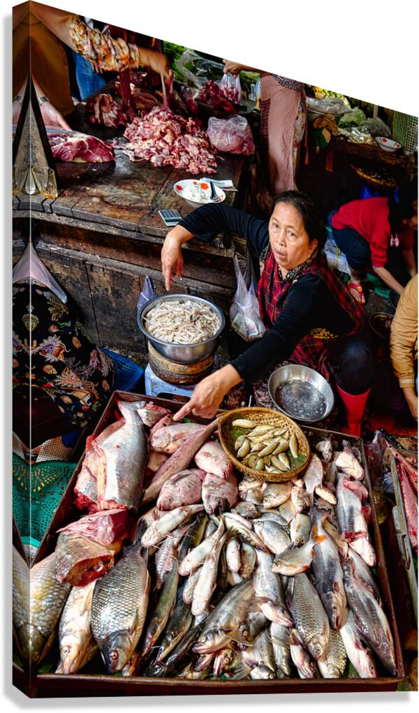 Asian market vendor selling fresh fish and meat.