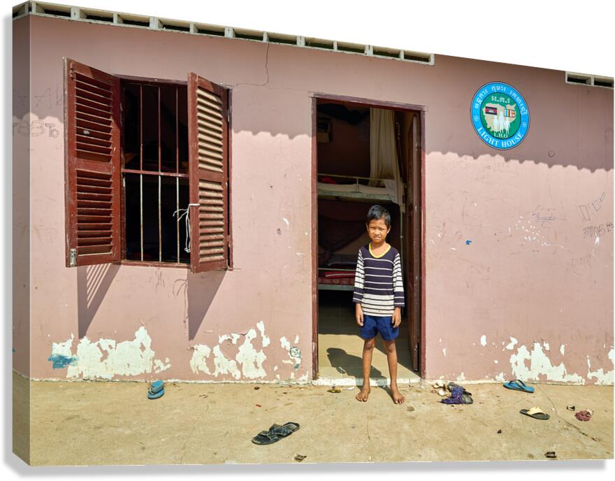 Barefoot boy in front of Lighthouse building.
