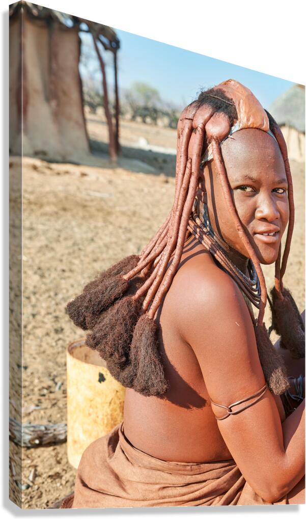 Himba woman in her village wearing traditional hair headdress