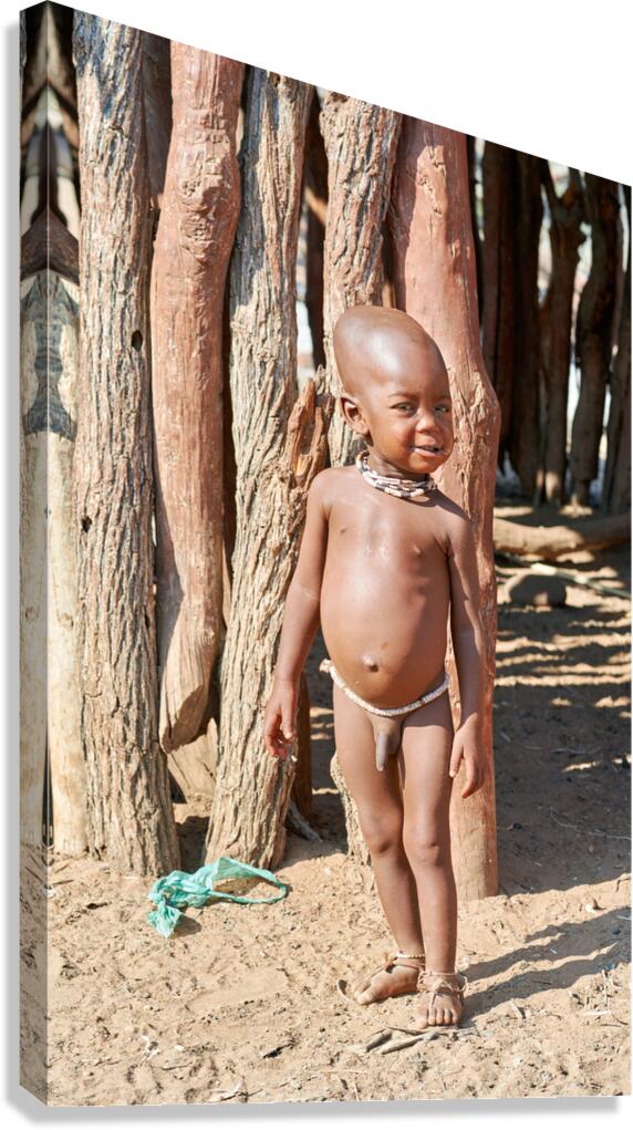 Child standing outside in a Himba village in Kunene Region Namib