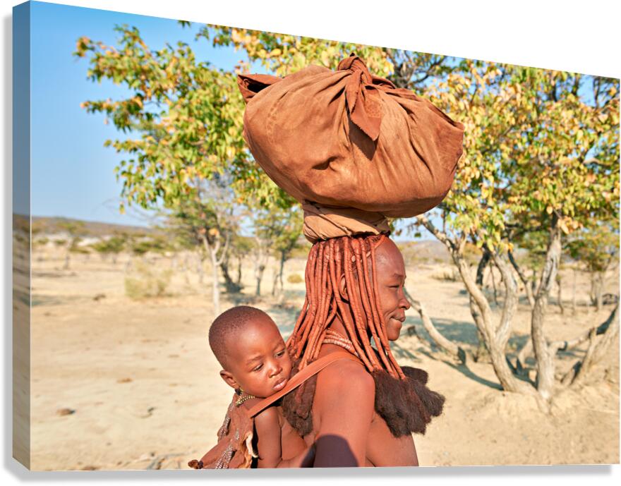 Portrait of Himba woman carrying her baby in Kunene region Nami