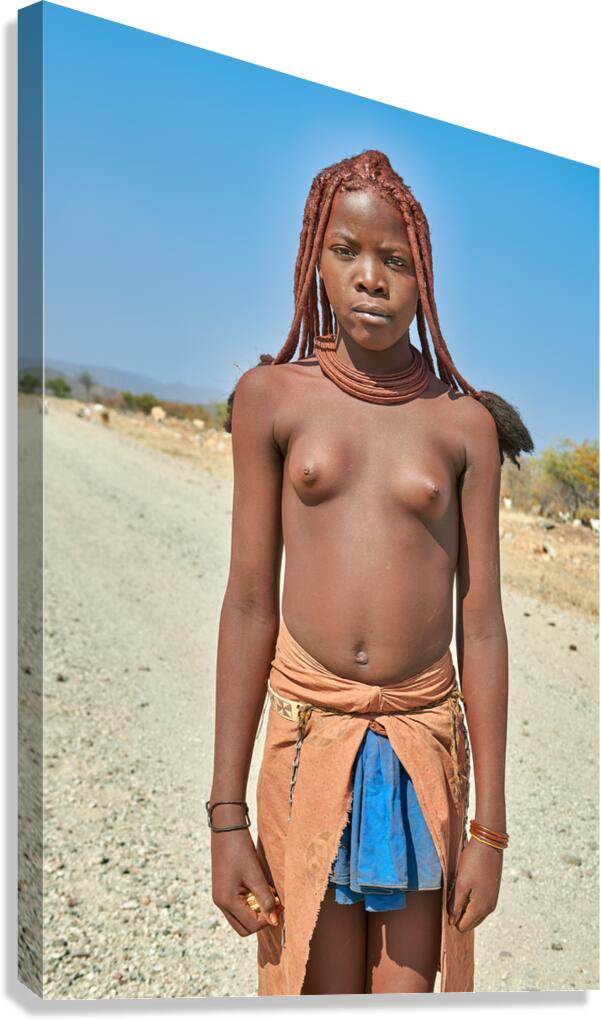 Himba woman standing on a road in Kunene region of Namibia