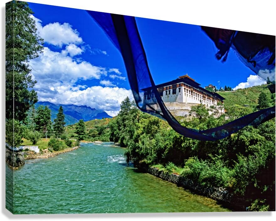 Bhutanese monastery river mountains and prayer flag.