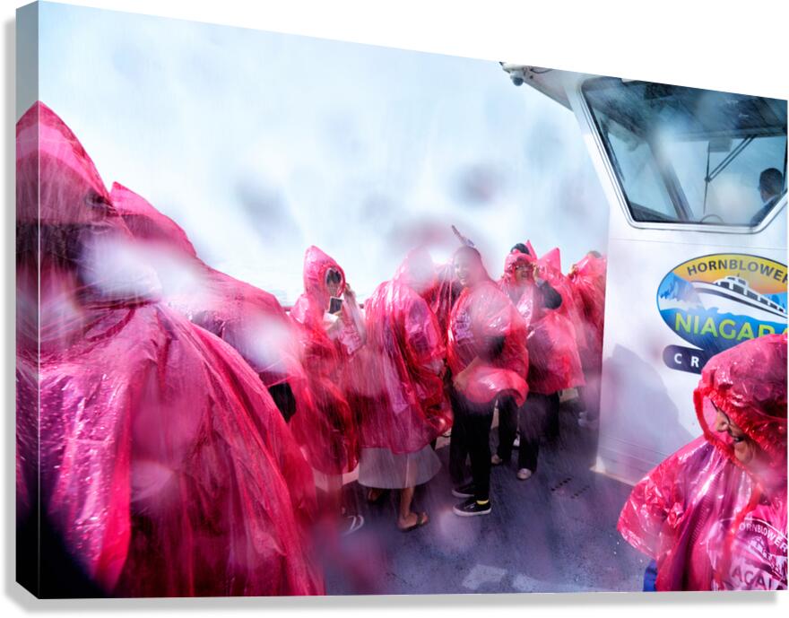 Pink ponchoed tourists on a misty Hornblower Niagara Falls cruis