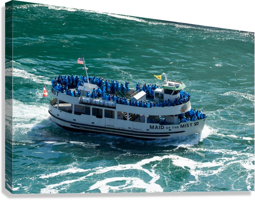 Maid of the Mist boat carrying tourists through water.
