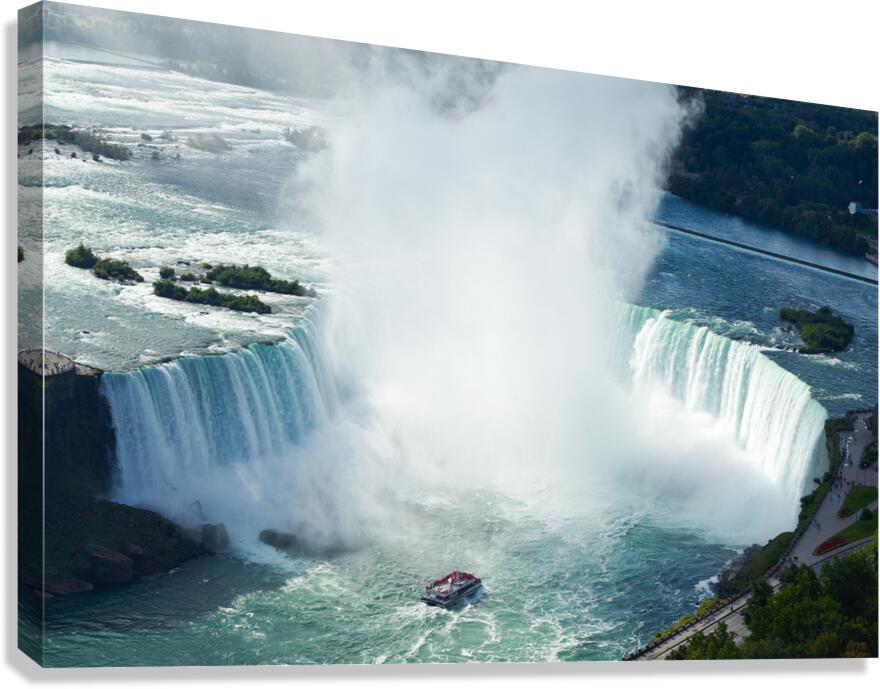 Majestic Niagara Falls a boat braves the mist.