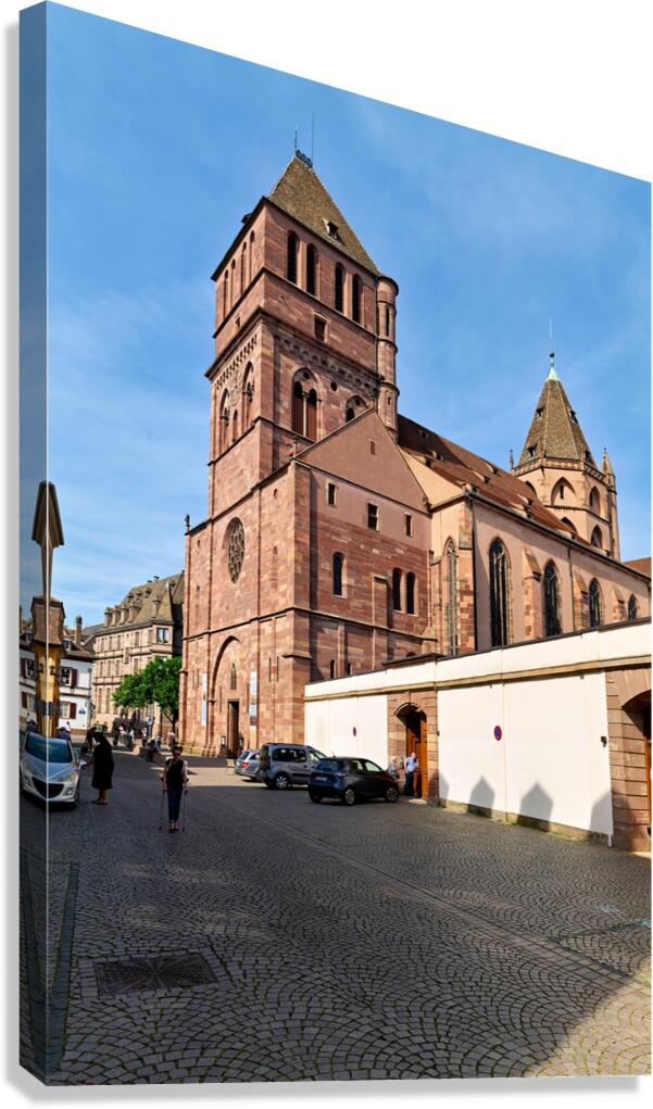 Saint Thomas church in Strasbourg with people walking nearby