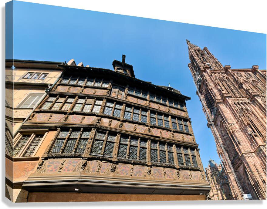 Visitors walk by Kammerzell House and Cathedral in Strasbourg