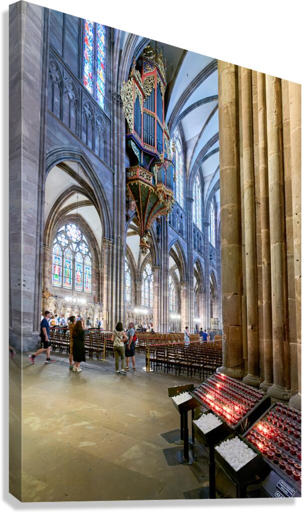 Visitors explore Strasbourg Cathedral with the grand organ pipe