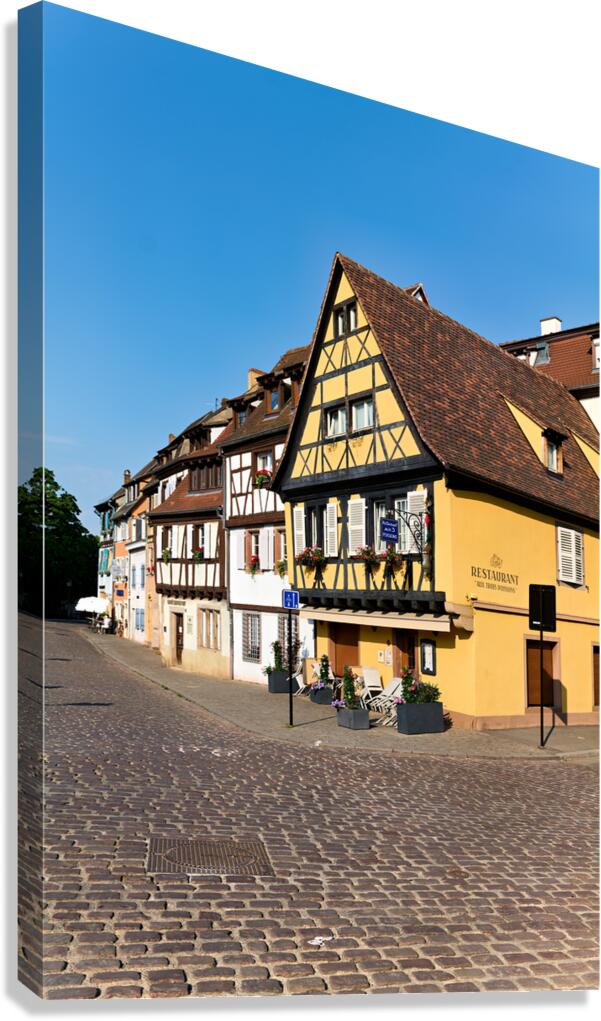 Visitors walk in Petite Venise while exploring timber framed hou