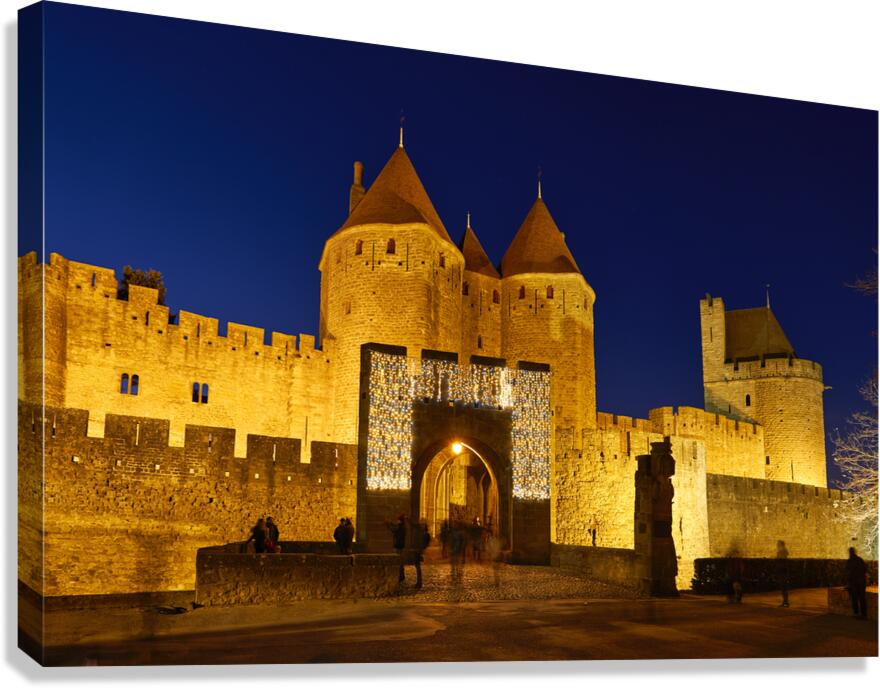 Visit to Carcassonne castle at night with lights around entryway