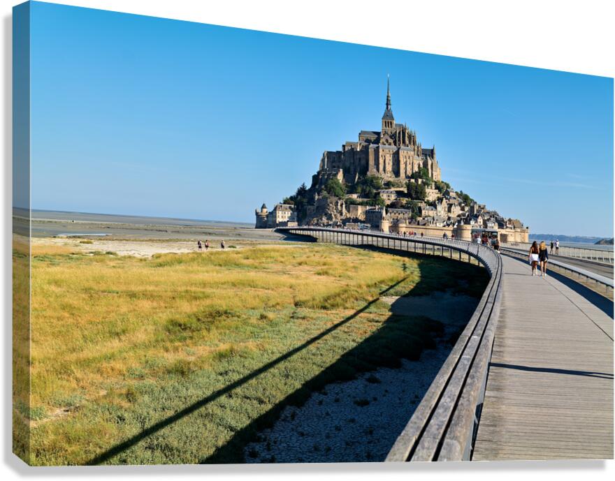 Tourists walking on bridge to Mont Saint Michel in Normandy Fran