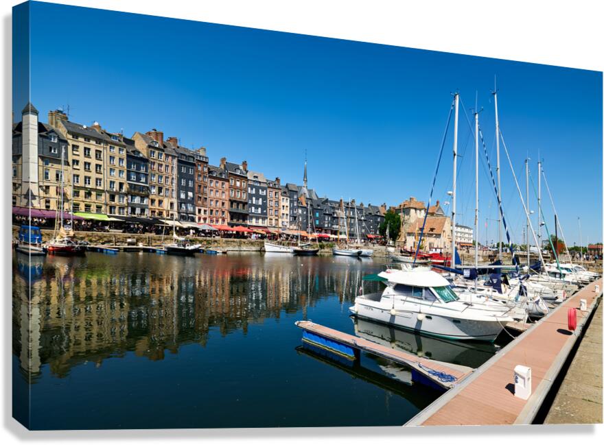 Boats docked at Honfleur harbor in Normandy France during a sunn