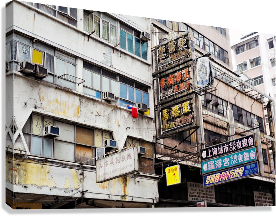 Weathered city buildings in Hong Kong with Chinese signs and lau