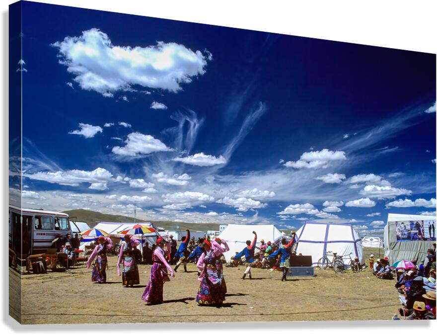 Outdoor festival in Tibet with traditional dancing and tents
