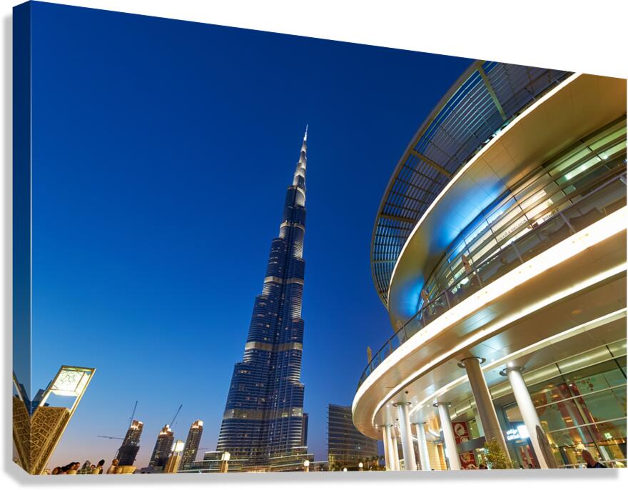 Burj Khalifa at night with modern buildings in Dubai skyline