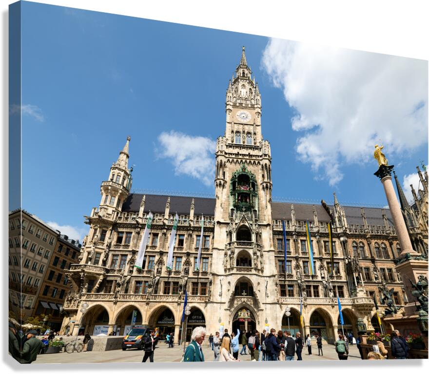 Tourists explore Munichs town hall in Marienplatz on a sunny da
