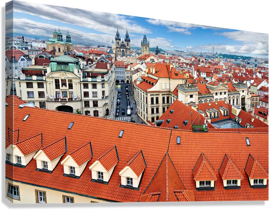 Panoramic view of Pragues red roofs and historic skyline.