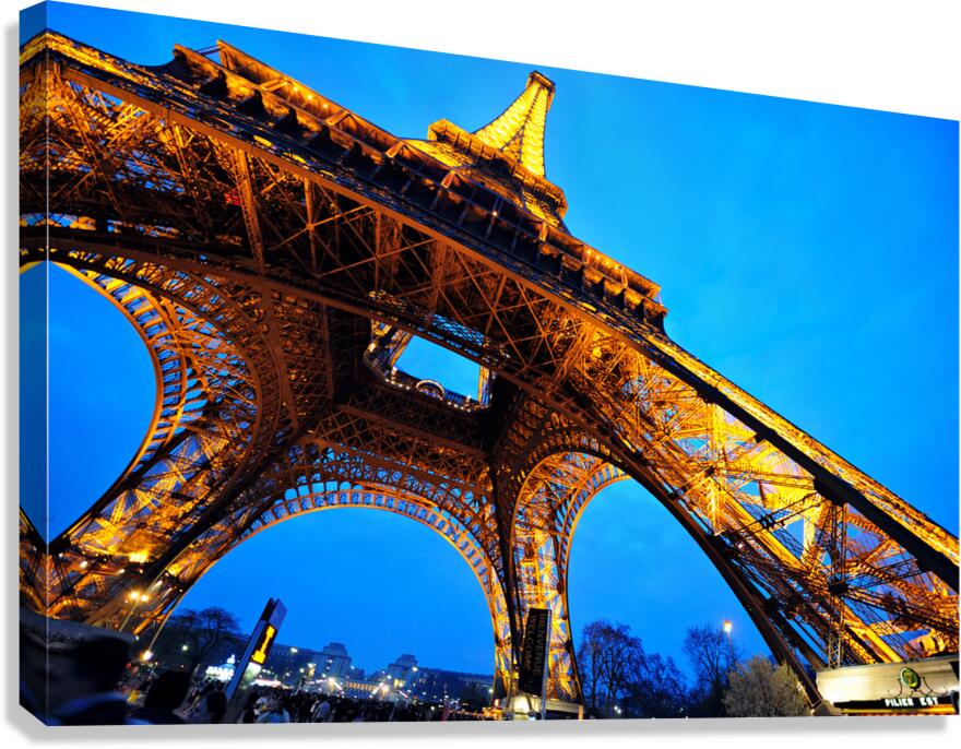 Eiffel Tower stands bright against darkening sky in Paris