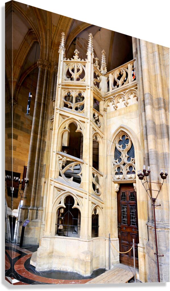 Ornate Gothic stone structure and door inside a cathedral.