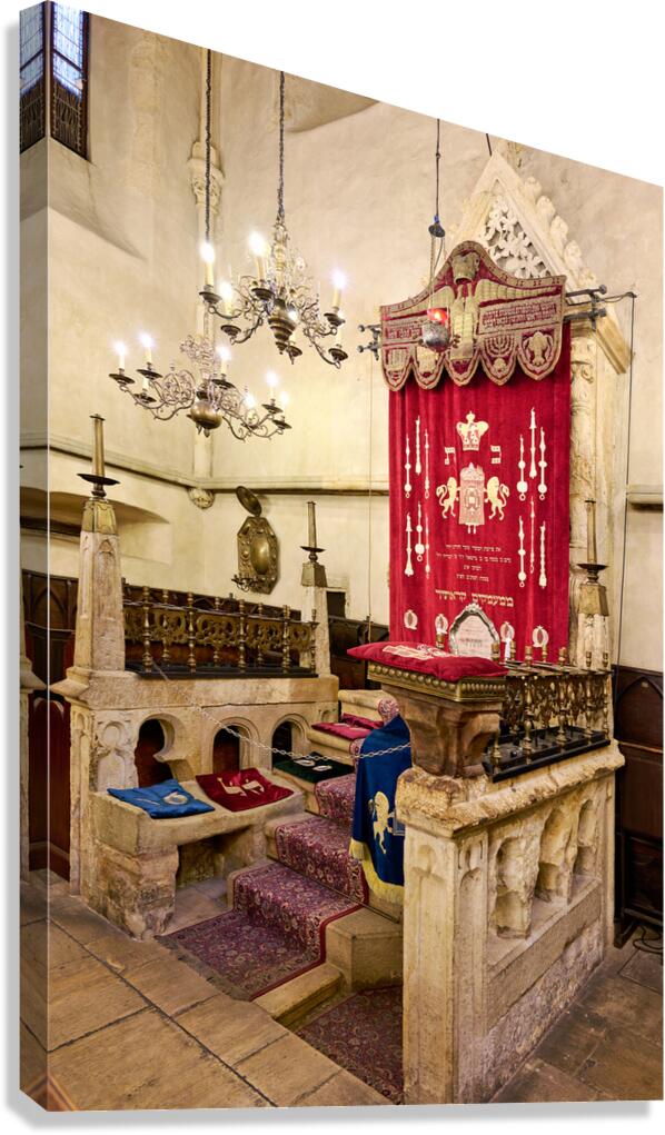 Historic synagogue interior with ornate Ark and bimah.