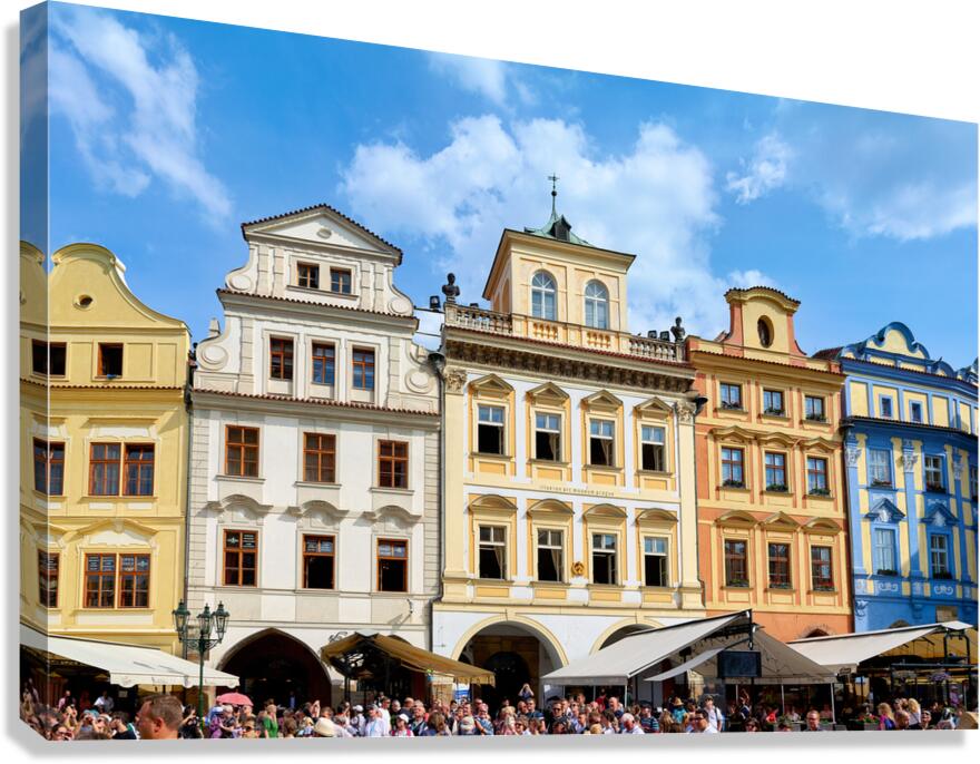 Colorful historic buildings and a lively crowd in a European squ