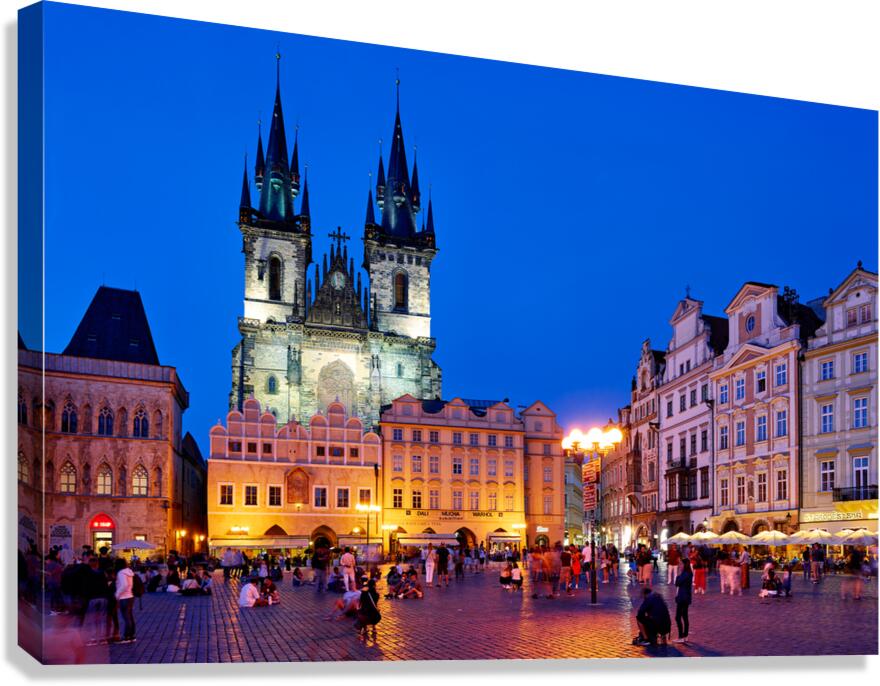 Pragues Old Town Square Týn Church bustling at night.