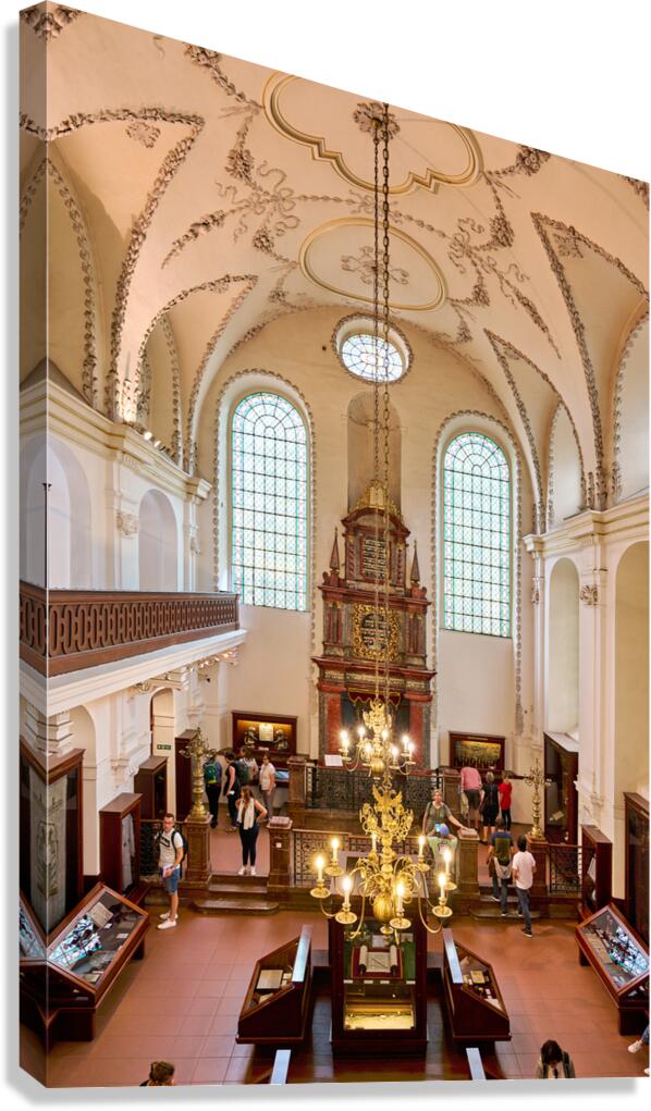 Ornate synagogue interior with tourists chandelier and stained
