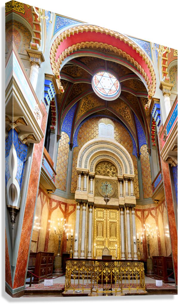 Ornate synagogue interior with golden ark and colorful decoratio