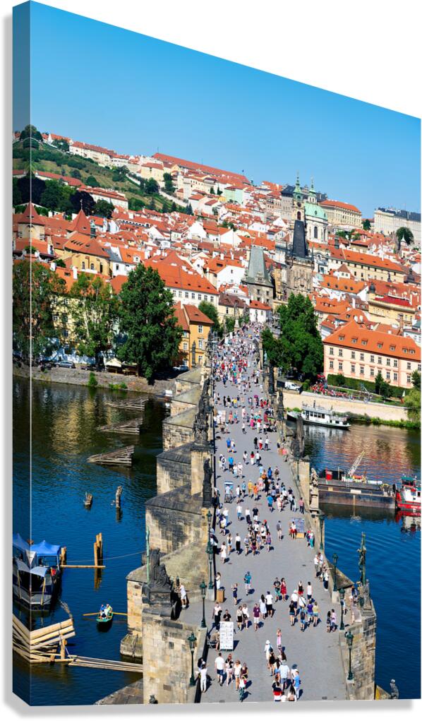 Iconic Charles Bridge Prague teeming with tourists.