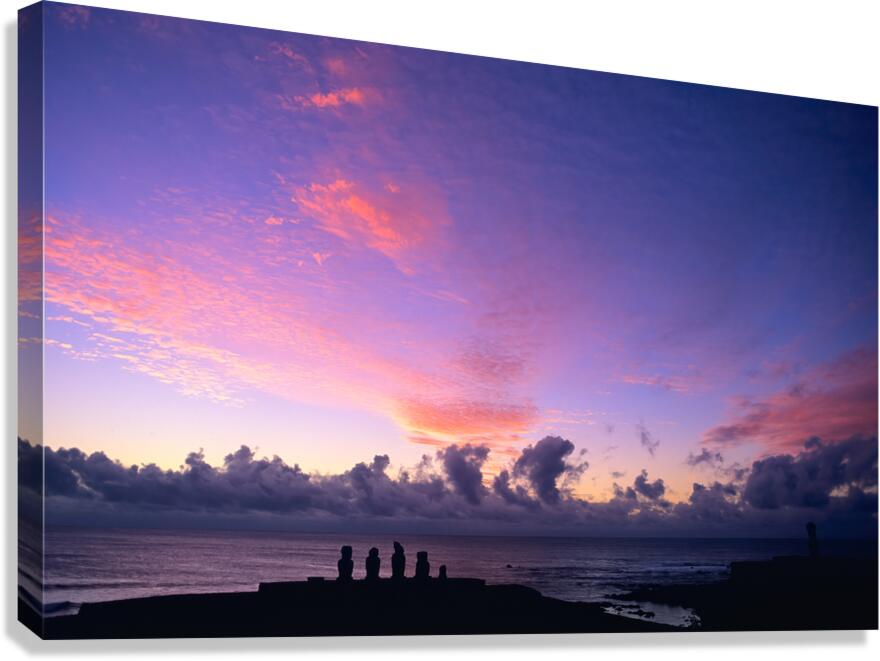 Moai silhouettes against a stunning purple and pink sunset.