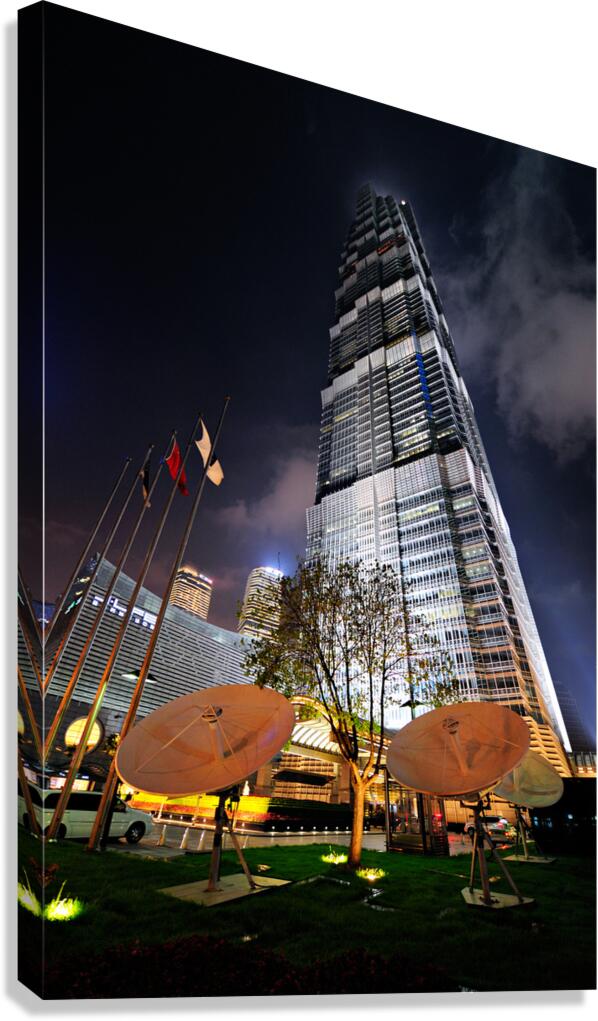 Modern skyscraper with satellite dishes at night in Shanghai Chi