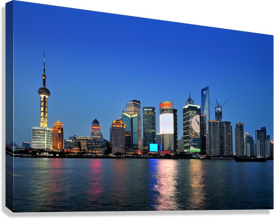 Shanghai skyline lights up at night over the river